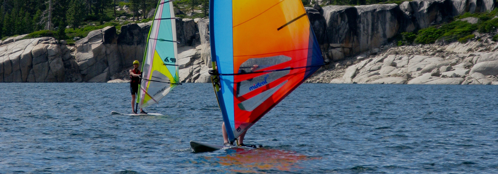 Campers challenging themselves on windsurfers