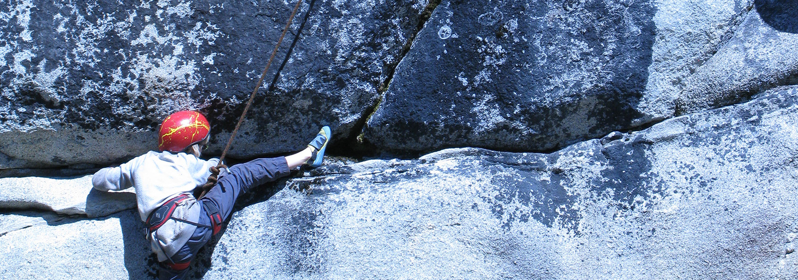 Camper learning to rock climb